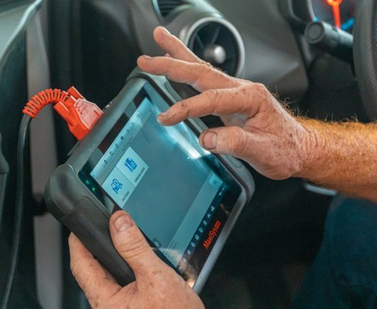 pexels photo 4116193 4116193 Mechanic using a diagnostic tool inside a car to check for engine issues and ensure proper maintenance.